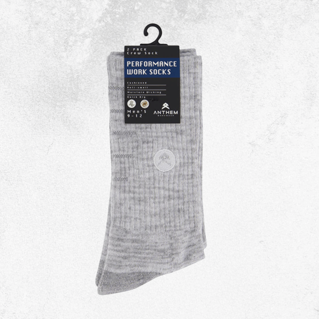 A pair of light gray ribbed crew socks hanging from a black plastic hanger with a black and blue retail tag. The tag reads 'PERFORMANCE WORK SOCKS' and shows the brand Anthem.