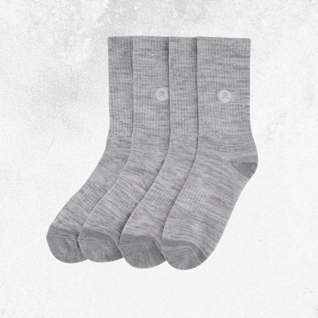 Three pairs of heather gray crew socks arranged side by side on a light textured background.