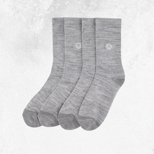 Three pairs of heather gray crew socks arranged side by side on a light textured background.