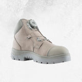 A light beige safety boot with a grey sole and a grey dial closure system on the side, shown against a textured light grey background.
