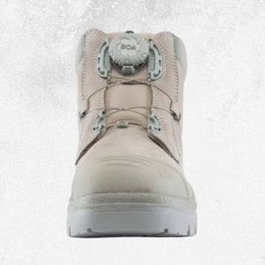 A single mid-calf work boot in a light beige/tan color with a gray BOA dial closure system and a white outsole, shown from a front-facing perspective against a light gray textured background.