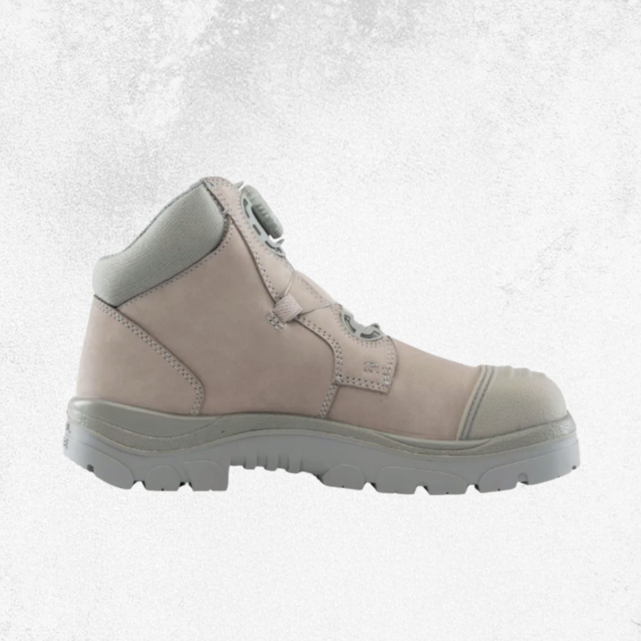 A light beige and gray safety boot with a lace-up front and protective toe cap, shown from a side profile against a textured light gray background.