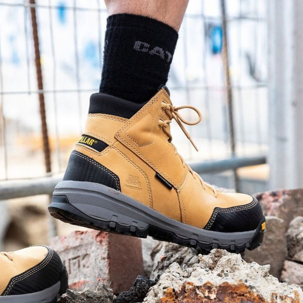 A man wearing CAT Device Zip Waterproof Composite Toe safety boot at work 