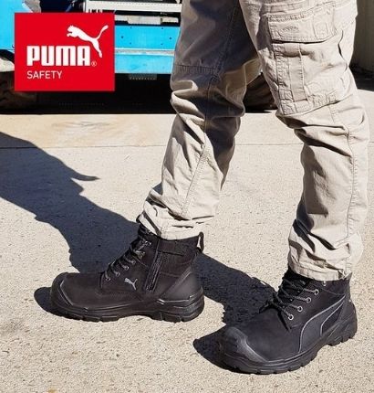 An individual wearing a pair of Puma Conquest FT Waterproof Boots outside