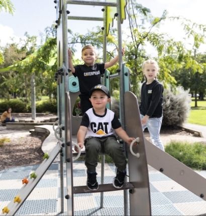 Clarico-Text Two images Kids wearing CAT Kids Trademark Cap - Black and sitting on a slide ladder