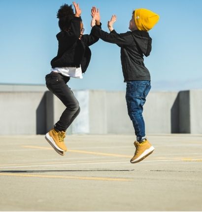 Two Kids Jumping and clapping hands. 