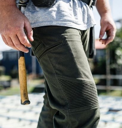 Tradie wearing JetPilot Fueled Corrugated Stretch Pant with hammer hanging from hip on job site. 