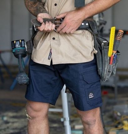 Tradie putting on tool belt wearing Unit Demolition Cargo Short