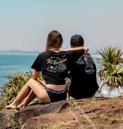 Couple Sitting on cliff overlooking beach