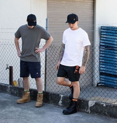 Two Men leaning against fence wearing the UNIT League Snapback Cap 