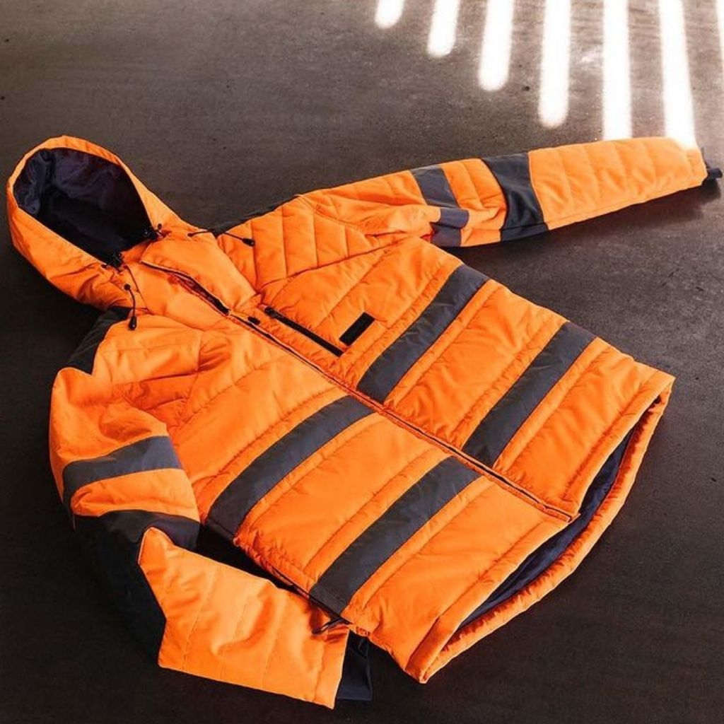 Hi Vis Boreaus Insulated Jacket laying on the ground of grey concrete. 