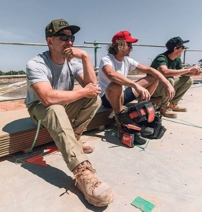 Men sitting down at work wearing JetPilot RX Men's Race Caps. 