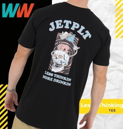Man wearing JetPilot Less Thinking Tee with crumpled paper background. 