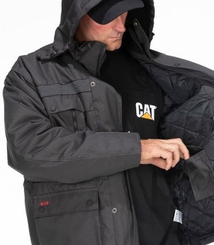 Man looking in jacket pocket wearing the CAT Heavy Insulated Parka