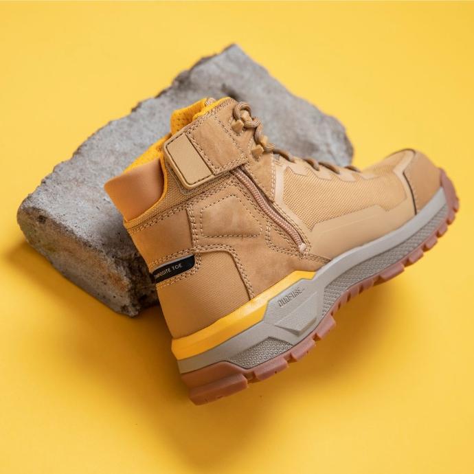 The Cat Propulsion boot on a concrete block with yellow background 