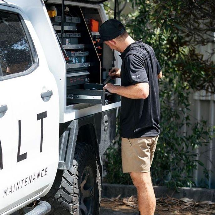 UNIT Prime Fitted Stretch Cap | ManCave Workwear Man working out of ute wearing UNIT Prime Fitted Stretch Cap