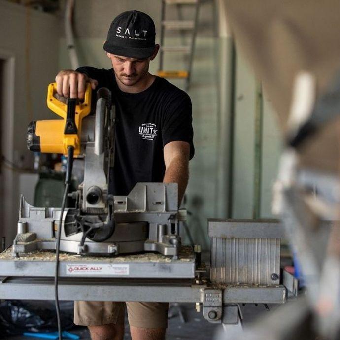 UNIT Mens Tee - Bridge | Mancave Workwear A man using a table saw wearing a UNIT Mens Tee Bridge at work.