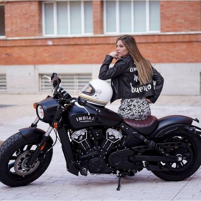 Indian Motorcycle Indian Bomber Girl Tank Tee | ManCave Workwear A girl sitting on an Indian motorcycle