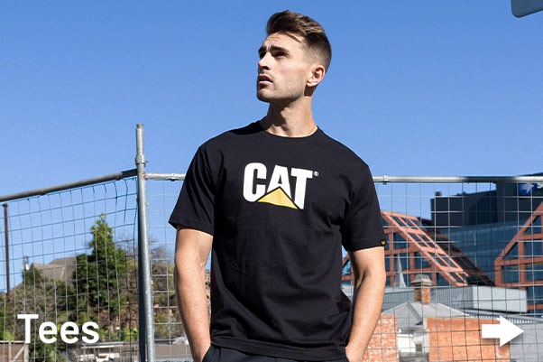 Australian Man wearing CAT Workwear tradie Black Tee shirt on construction site.