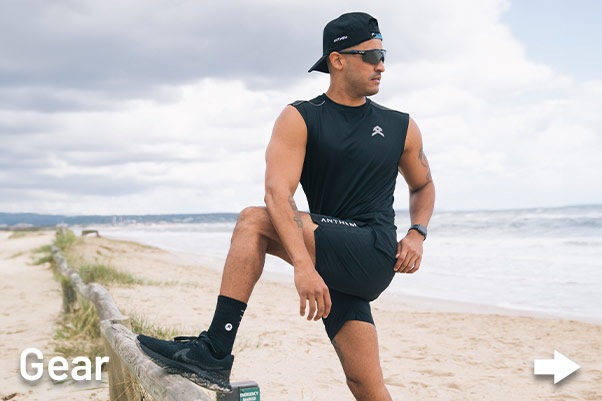 Australian Traide Man wearing Anthem Workwear clothing on beach to do fitness.