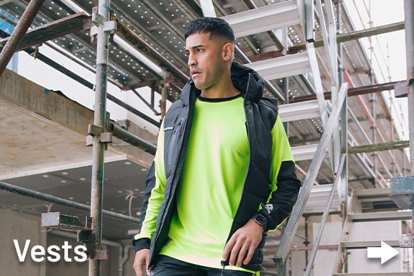 Australian Tradie Man wearing Anthem Workwear Vest and Shirt onsite at work.
