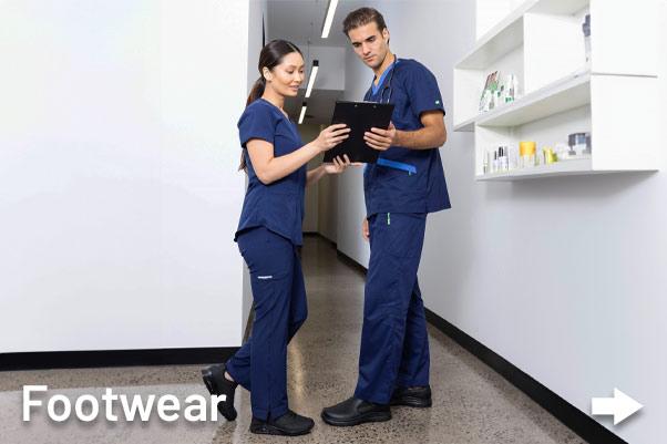 Two medical professionals wearing workwear shoes in hospital.