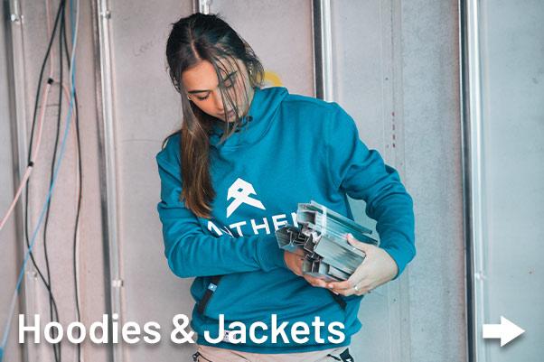 Women tradie wearing blue Anthem Workwear hoodie onsite in AUstralia.