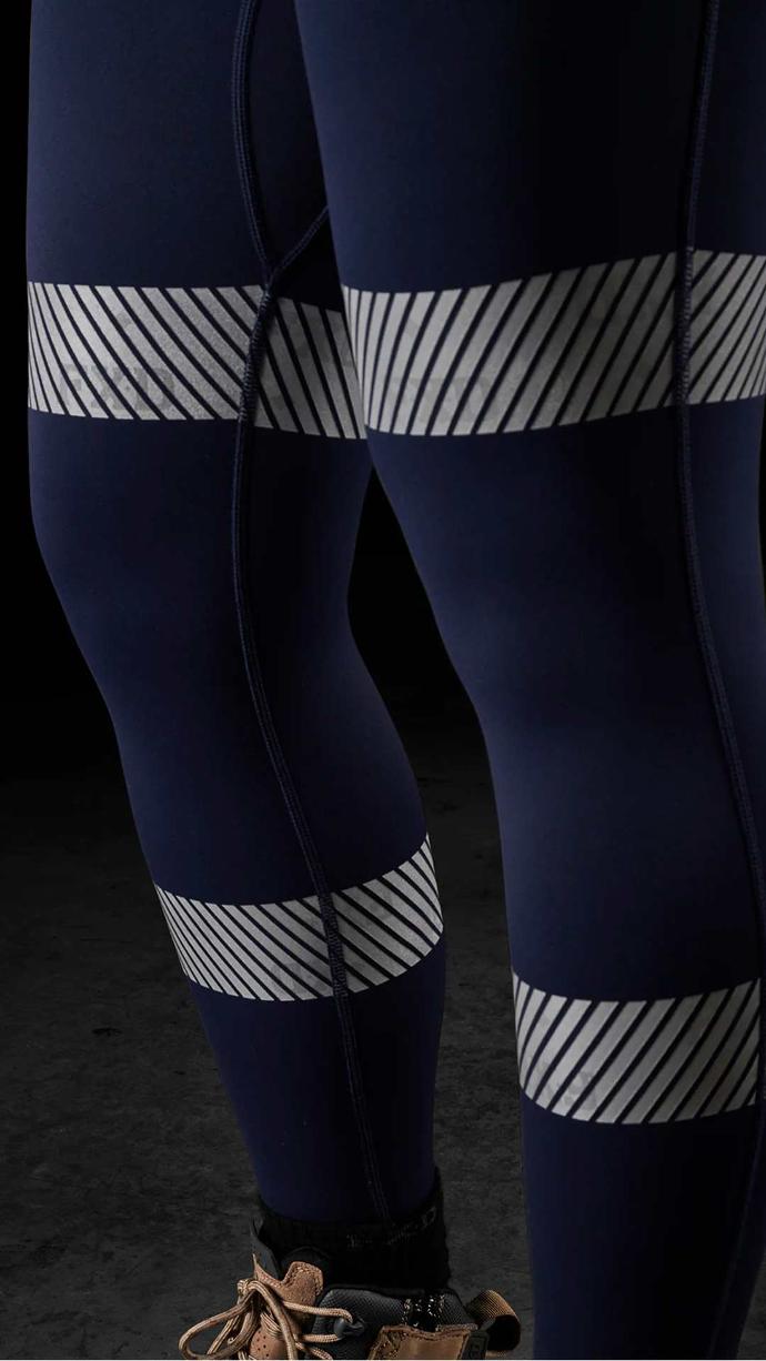 Tradie women wearing FXD WP-9WT Women's Taped Stretch Work Leggings in colour navy