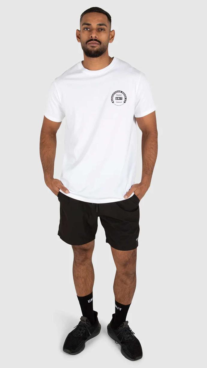 Man wearing white UNIT Men's Tee - Validate in studio